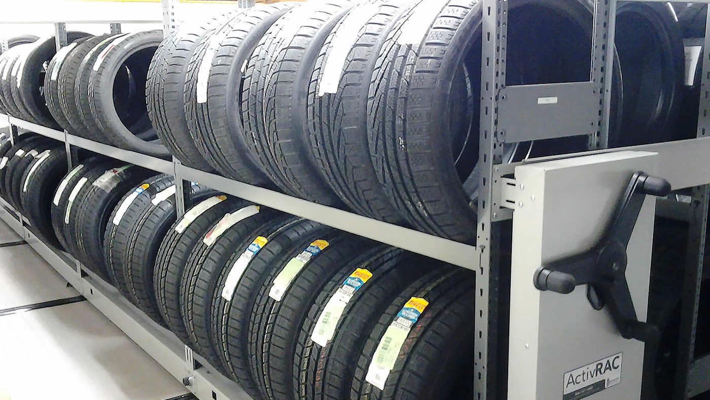 Tires being stored on mechanical assist storage system
