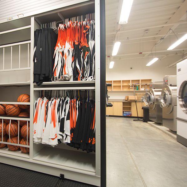 high school multi sport equipment room with ball and garment storage