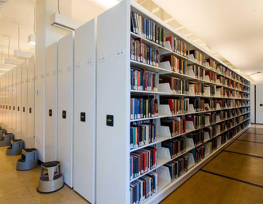 books on powered mobile shelving system in library
